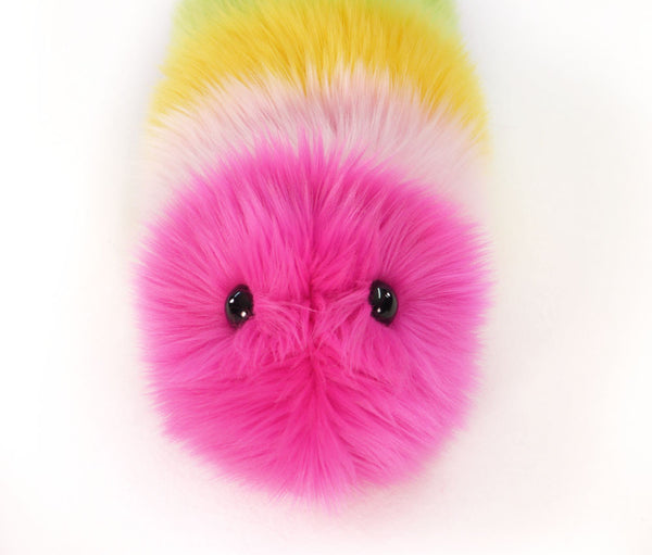 Girly rainbow snuggle worm stuffed animal plush toy close up view.